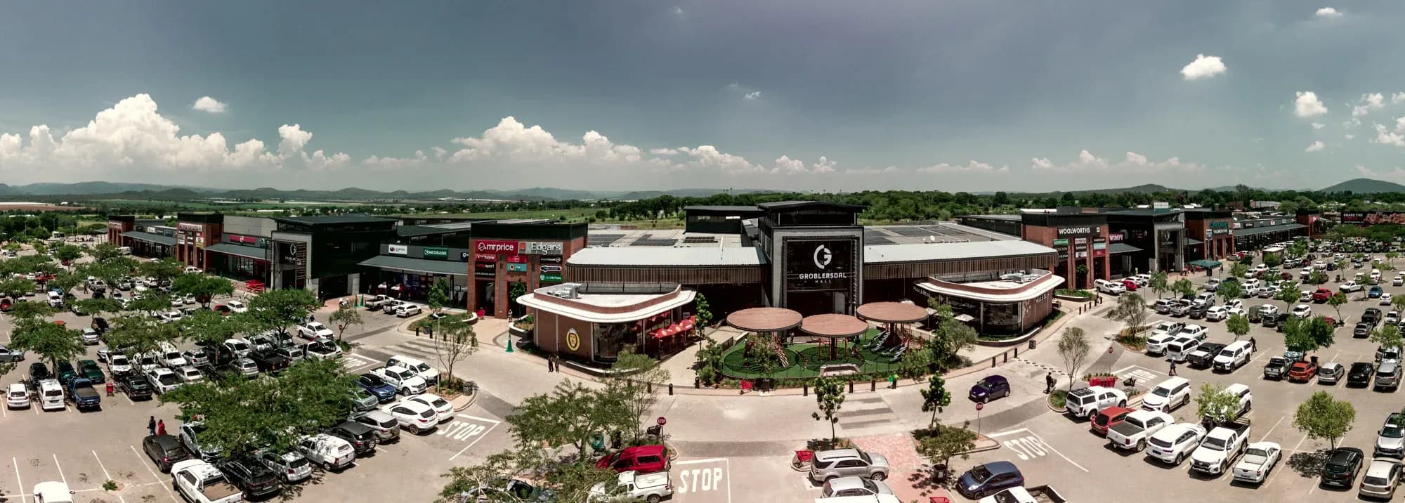 The shopfronts and entrance canopies of Groblersdal Mall, seen across the parking